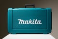 Photo of white Makita word on a green box with tools and instruments for repair. Construction tools set