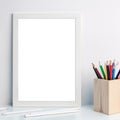 Photo of a white mockup frame with colorful pencils in a wooden toolbox Royalty Free Stock Photo