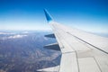 Photo from window of wing airplane flying over Alps mountains. Travel concept Royalty Free Stock Photo