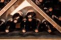 photo of wine bottles stacked on wooden racks in cellar Royalty Free Stock Photo