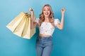 Photo of winning young girl fists up crazy cheap discount announcement shopaholic consumerism advert isolated on blue Royalty Free Stock Photo