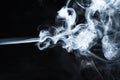 Photo of a wisp of smoke on a dark background