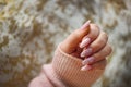 A photo of a woman's hand with beautiful pink gel nails. Royalty Free Stock Photo