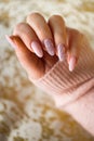 A photo of a woman's hand with beautiful pink gel nails. Royalty Free Stock Photo