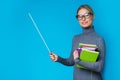 Photo of woman teacher with pointer and books in their hands Royalty Free Stock Photo