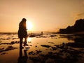 Photo of a siluet woman walking on the beach at dusk Royalty Free Stock Photo