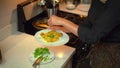 Photo of a woman who is seasoning the Arabic dish Pilaf