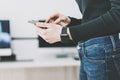 Photo Woman Working Modern studio,Wearing Generic Design Smart Watch.Female Hands Touching screen mobile phone.Manager Royalty Free Stock Photo