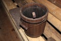 Wooden old water bucket in the bath Royalty Free Stock Photo
