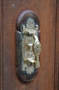 Wooden door handle with interesting golden detail on it Royalty Free Stock Photo