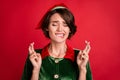 Photo Of Worried Helper Lady Close Eyes Crossed Fingers Bite Lip Wear Elf Costume Hat Isolated Red Color Background