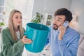 Photo of worried spouses lady guy have apartment trouble water drops falling from ceiling call plumber smartphone