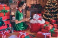 Photo of writer delivery worker lady sit table write wish list wear elf costume in decorated office indoors