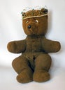 Photo of a 45-year-old bear with a homemade pearl crown on his head,handmade