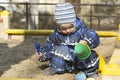 A 2-year- old boy playing in a sandbox Royalty Free Stock Photo