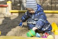 A 2-year- old boy playing in a sandbox Royalty Free Stock Photo