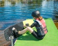 Photo 13-year-old teenage Girl in sports protective gear and helmet getting ready for training at Wake Park. Water sport. Leisure Royalty Free Stock Photo
