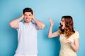 Photo of yelling wife it`s your fault negative expression husband hiding ears wear casual t-shirts isolated blue