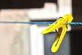 photo of a yellow clothespin on a blue lace