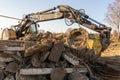 Photo of a yellow excavator with a bucket trying to lift more than its own weight