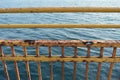 Yellow rusted fence and sea in background