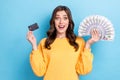 Photo of young adorable pretty attractive positive woman hold money cash dollars credit card positive excited isolated Royalty Free Stock Photo