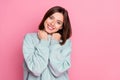 Photo of young adorable woman hands touch warm sweater toothy smile isolated over pink color background Royalty Free Stock Photo