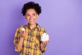 Photo of young african girl happy positive smile eat marshmallow diet calories isolated over purple color background