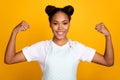 Photo of young african girl show arms muscle stength ready to clean the house isolated over yellow color background