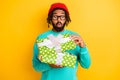 Photo of young african man amazed shocked surprised open gift present box birthday isolated over yellow color background