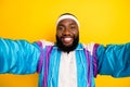 Photo of young african man happy positive smile make selfie blogger trip sporty isolated over yellow color background