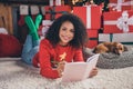 Photo of young african woman happy positive smile write notebook plan puppy christmas gift box indoors Royalty Free Stock Photo