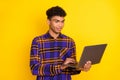 Photo of young afro man look browse laptop chat type email programmer isolated over yellow color background