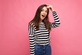 Photo of young amazed shocked positive beautiful brunette woman with sincere emotions wearing casual striped pullover Royalty Free Stock Photo