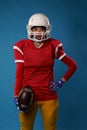 Photo of young american woman football player in white helmet, sportswear with ball in her hand Royalty Free Stock Photo