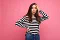 Photo of young astonished surprised beautiful brunette woman with sincere emotions wearing casual striped pullover Royalty Free Stock Photo
