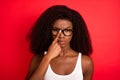 Photo of young attractive afro girl unhappy upset moody fix eyeglasses isolated over red color background