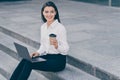 Photo of young attractive beautiful positive smiling cheerful businesswoman working in laptop drink coffee outside Royalty Free Stock Photo