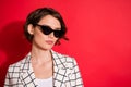 Photo of young attractive business woman serious confident wear sunglass look empty space isolated over red color Royalty Free Stock Photo
