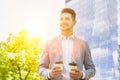 Portrait of young attractive businessman holding two cups of coffee Royalty Free Stock Photo