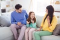 Photo of young attractive family mom dad child happy positive smile speak talk conversation sit couch indoors Royalty Free Stock Photo