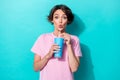 Photo of young attractive funny cute woman hold blue cola drinking pouted lips surprised low prices isolated on cyan