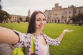 Photo of young attractive girl happy positive smile make selfie smartphone show demonstrate hand university travel Royalty Free Stock Photo