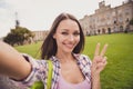 Photo of young attractive girl happy positive smile shoot selfie cell phone how peace cool v-sign travel outdoors Royalty Free Stock Photo