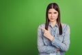 Photo of young attractive girl indicate finger empty space advertise decision isolated over green color background Royalty Free Stock Photo