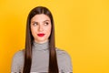 Photo of young attractive girl think thoughtful pensive look empty space isolated over yellow color background