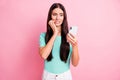 Photo of young attractive lovely sad unhappy nervous girl bite fingers hold smartphone isolated on pink color background