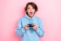 Photo of young attractive nice excited pretty girl wear blue hoodie open mouth shock hold gamepad player addicted