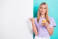 Photo of young attractive pretty cute blonde entrepreneur finger direct empty space looking ebay shopping phone isolated Royalty Free Stock Photo