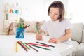 Photo of young attractive school girl concentrated focused moody paint picture pencil sit couch home